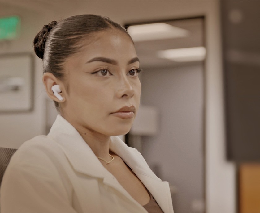 woman working with earphones in at a desk